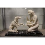 A good Art Deco alabaster and marble group modelled as a seated female nude with a Borzoi dog