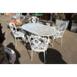 An aluminium patio table and four armchairs.