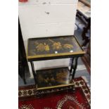 A chinoiserie decorated two tier ebonised table.