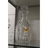 A good cut glass decanter with gilded and enamelled armorial crest.