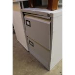 A metal two drawer filing cabinet.