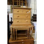 A small pine three drawer chest and a nest of pine tables.