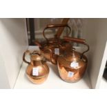 Two copper kettles and a small copper jug.