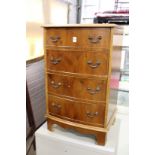 A small yew wood chest of drawers.