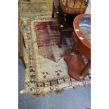 An old Persian rug, worn and cut.