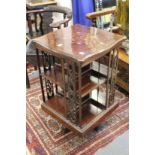 An inlaid walnut revolving bookcase.