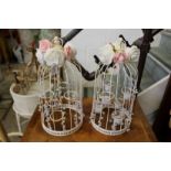 A pair of decorative bird cage style tea light holders.