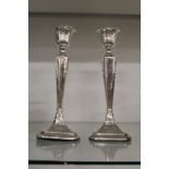 A pair of silver candlesticks.