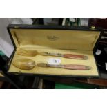 A good cased pair of horn handled salad servers.