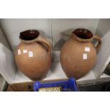 A pair of large terracotta jugs.