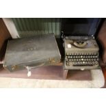 A leather writing case and an old typewriter.