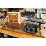 An old typewriter, sewing machine, projector and screen.