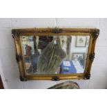 A gilt framed mirror.