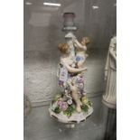 A continental porcelain figural candlestick group.