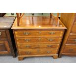 A 19th century mahogany and inlaid four drawer chest with brushing slide on bracket feet.