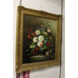 A still life of flowers in a vase on a ledge, oil on board, in a decorative gilt frame