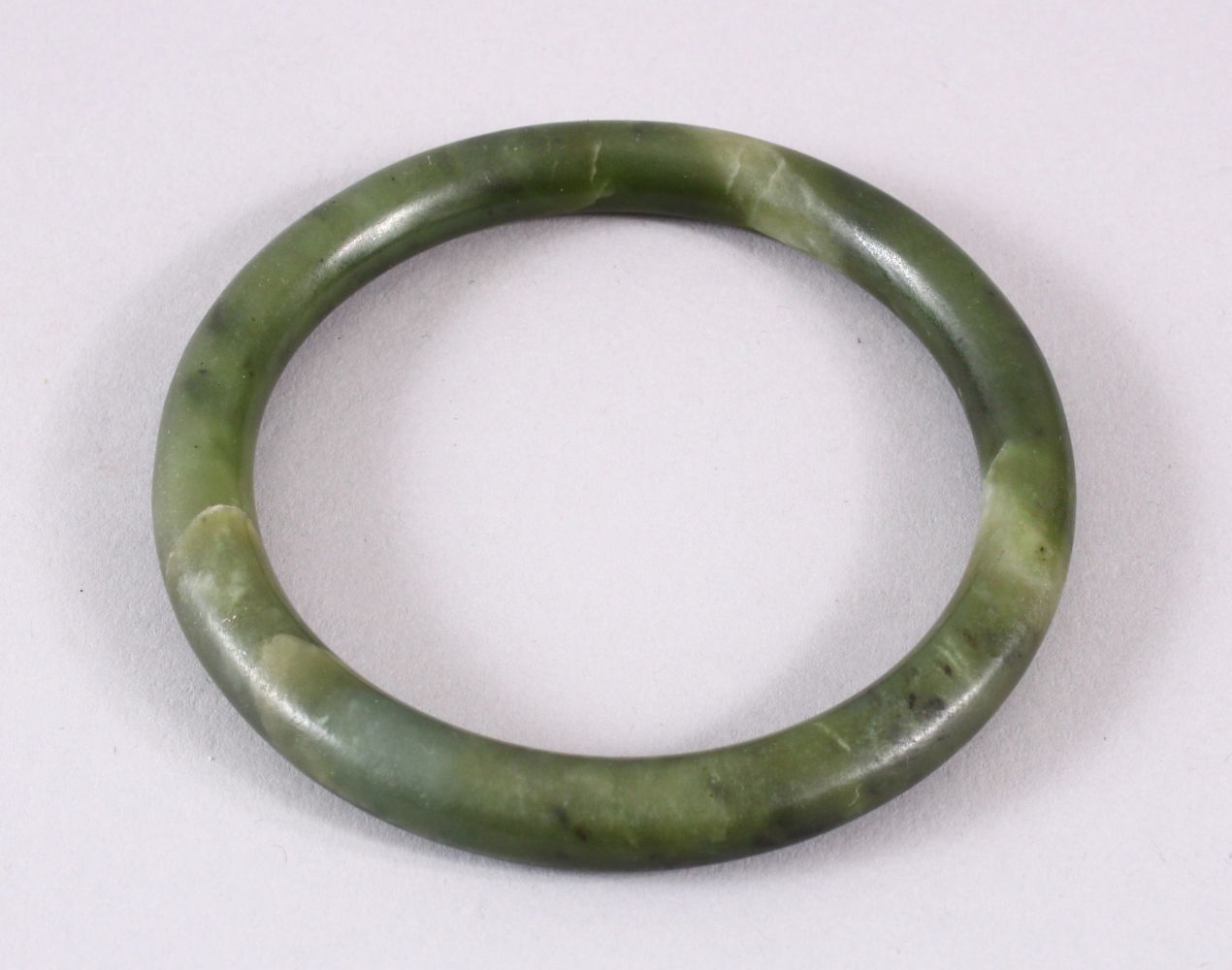 A CHINESE CARVED JADE BANGLE, 8CM