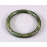 A CHINESE CARVED JADE BANGLE, 8CM