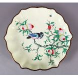 A CHINESE ENAMEL PEACH BLOOM DISH, the dish with a pale yellow ground depicting a bird seated in the