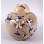 A 19TH CENTURY CHINESE CRACKLEGLAZE GINGER JAR AND COVER, decorated with flowers and blue leaves,