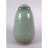 AN UNUSUAL THAI CELADON SAWAHKHALOK POTTERY VASE, with twin handles and a moulded / carved body of