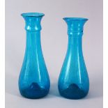 TWO 18TH CENTURY PERSIAN BLOWN GLASS TURQUOISE BOTTLE VASES, 19cm and 19.5cm.