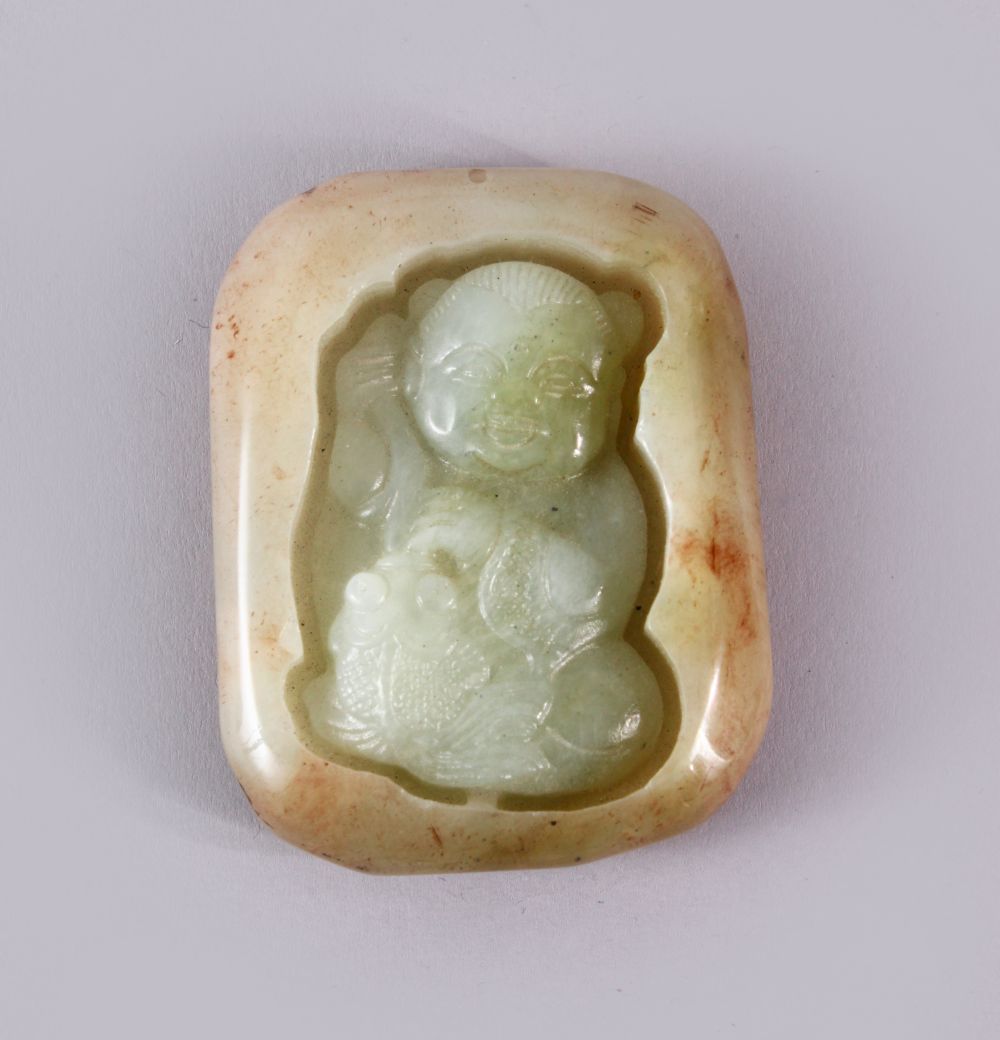 A CHINESE CARVED JADE PENDAND OF A BOY - the jade pebble carve din deep relief depicting a seated