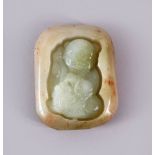 A CHINESE CARVED JADE PENDAND OF A BOY - the jade pebble carve din deep relief depicting a seated