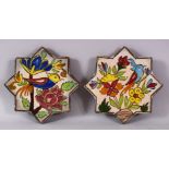 A SMALL PAIR OF IRANIAN POTTERY STAR FORMED TILES, each decorated with scenes of birds and flora,