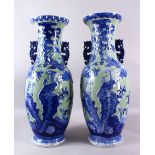 A LARGE PAIR OF 19TH / 20TH CHINESE CENTURY CELADON BLUE & WHITE PORCELAIN VASES, each decorated