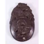 A 19TH/20TH CENTURY INKSTONE AND CIRCULAR COVER, carved with dragons and birds, 16cm x 11cm.