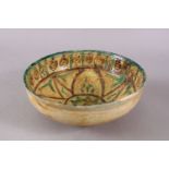 A GOOD IRAN STYLE POTTERY BOWL, decorated with green & biscuit grounds with floral motifs, 21cm.