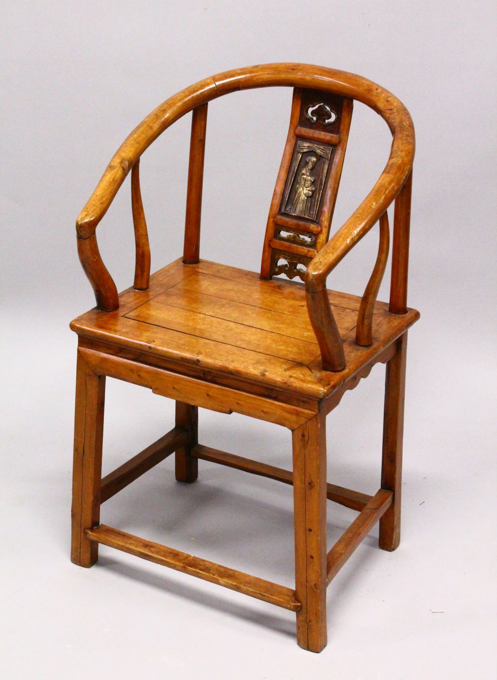 A CHINESE CARVED WOOD HOOP BACK ARM CHAIR, the back panel carved with a figure and openwork with