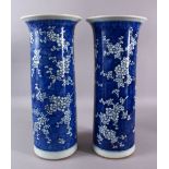 A LARGE PAIR OF 19TH CENTURY CYLINDRICAL BLUE AND WHITE PRUNUS VASES, both approx. 45cm high.