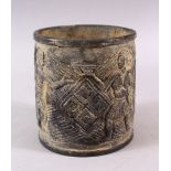 AN EASTERN? STONE CARVED FIGURAL BRUSH POT / VASE, carved with figures, 16cm high x 14cm diameter (