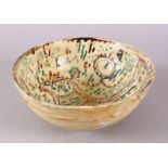 A GOOD IRAN STYLE POTTERY BOWL, decorated with green & biscuit grounds, carved with the view of a