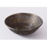 A 19TH CENTURY ISLAMIC CALLIGRAPHIC BRONZE MAGIC BOWL, with carved bands of calligraphy and interior