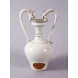 A RARE CHINESE DING STYLE TWIN DRAGON HEAD HANDLE JAR - the body with and oval unglazed panel of