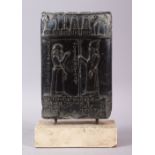 A MESOPOTAMIAN BABYLONIAN STYTLE CARVED BLACK TABLET, carved with two figures and objects, with