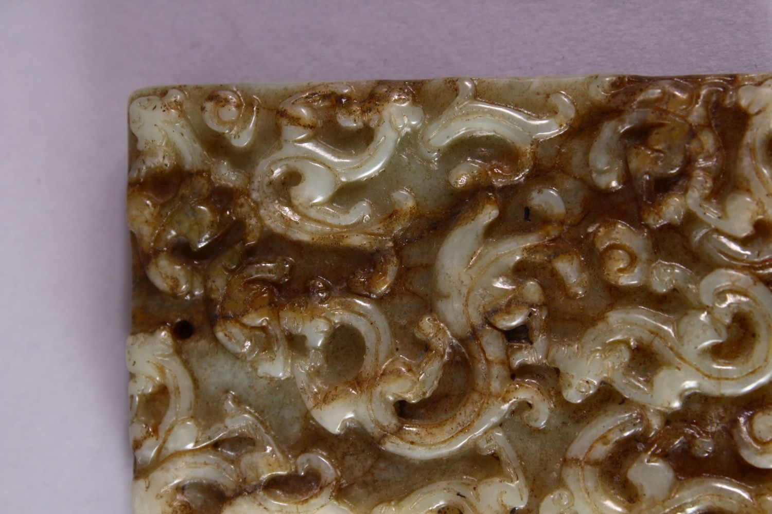 A 19TH CENTURY SPECKLED JADE RECTANGLAR TABLET, carved with scrolls, 6.5cm x 4.5cm. - Image 2 of 3