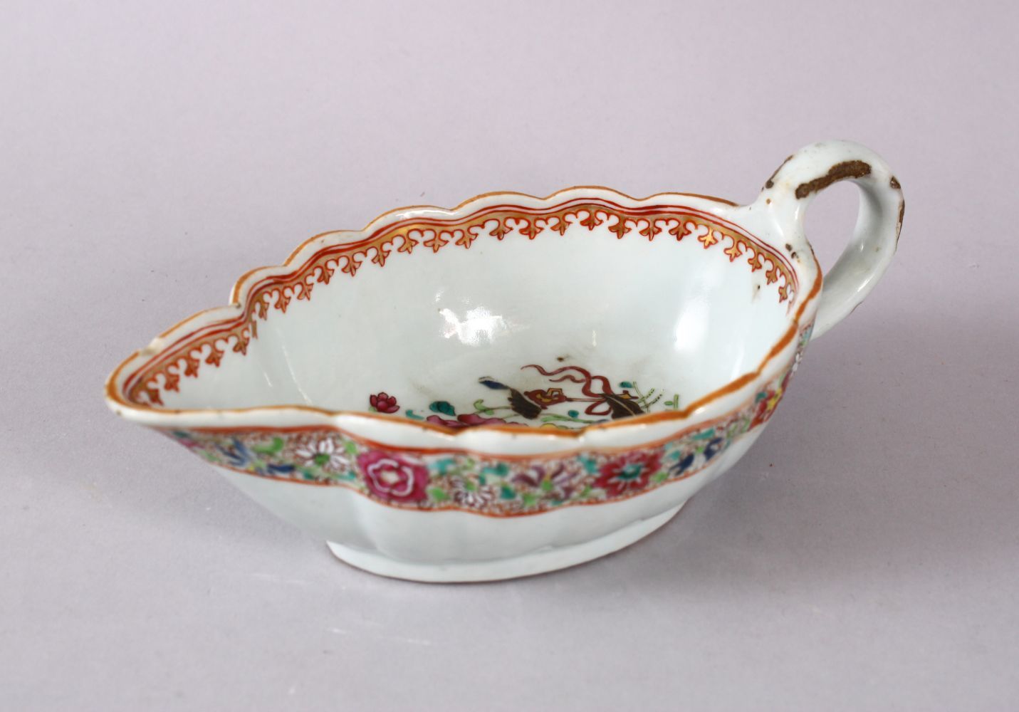 AN 18TH CENTURY CHINESE EXPORT FAMILLE ROSE PORCELAIN SAUCE BOAT, decorated with scenes of flora and