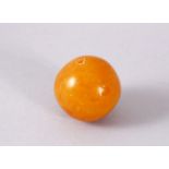 A GOOD & LARGE EGG YOLK AMBER CARVED BEAD, 4CM , 30GMS.