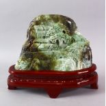 A LARGE CHINESE JADE STONE LANDSCAPE CARVING, depicting a native landscape built upon a