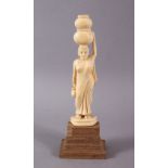 A 19TH CENTURY INDIAN CARVED IVORY FIGURE of female carrying a water vessel, 16cm high.