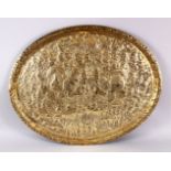 A 19TH CENTURY INDIAN EMBOSSED BRASS TRAY, with decoration depicting many scenes of figures and