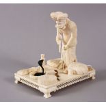 A GOOD 19TH CENTURY INDIAN CARVED IVORY GROUP OF A SNAKE CHARMER, standing charming a cobra from a