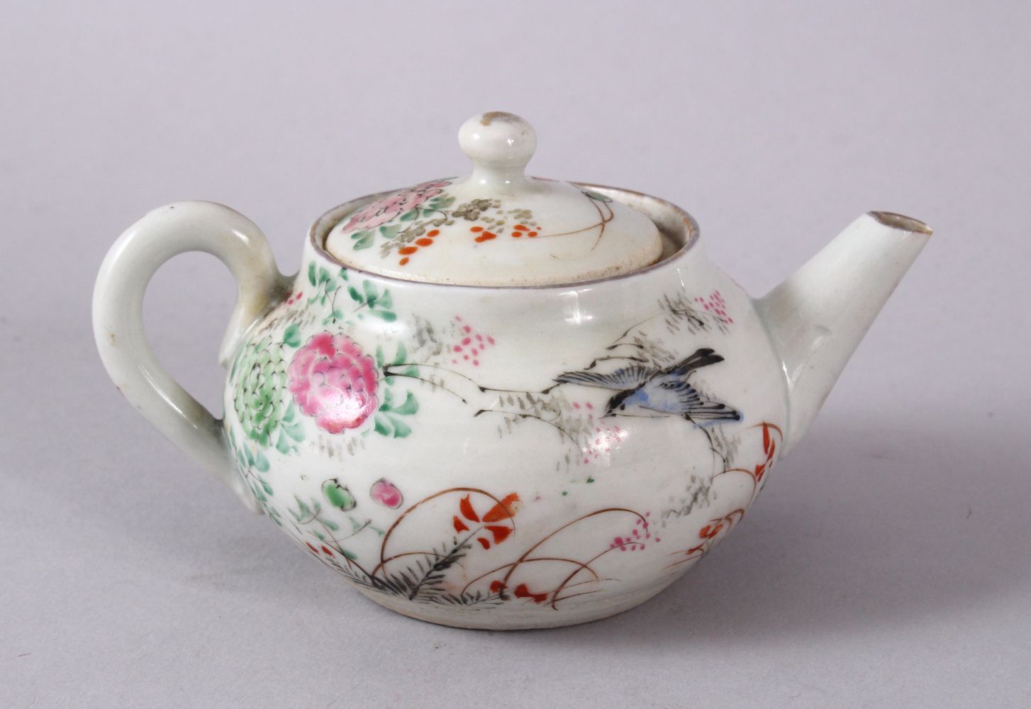 A SMALL CHINESE FAMILLE ROSE TEAPOT & COVER, decorated with native scenes of flora and birds, the