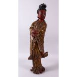 A LARGE CHINESE WOOD & LACQUER FIGURE OF GUANYIN, stood holding a scroll with her hands crossed,