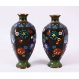 A PAIR OF CHINESE CLOISONNE BLACK GROUND VASES - each with a black ground and roundel decoration