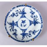 A CHINESE BLUE & WHITE PORCELAIN DISH - decorated with native floral sprays around a central